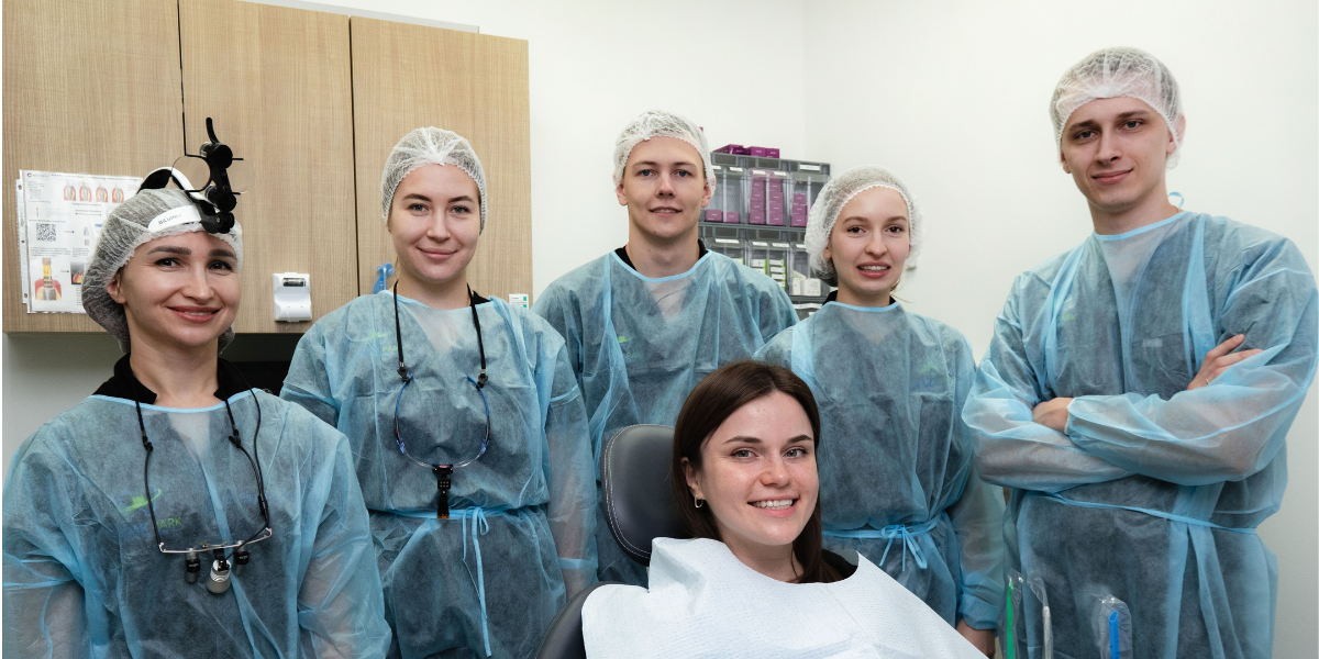 Surgical team prepared for wisdom teeth removal procedure with patient in sterile environment using advanced dental equipment